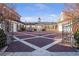 Long view of estate courtyard with brick paving stones, colonnade, and access to the garages at 5200 Moore Rd, Suwanee, GA 30024