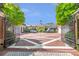 Gated entrance to a beautiful bricked circular driveway with lush landscaping at 5200 Moore Rd, Suwanee, GA 30024
