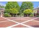 Beautiful bricked circular driveway with lush landscaping and gated entry at 5200 Moore Rd, Suwanee, GA 30024