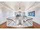 Grand foyer with staircase, hardwood floors, decorative chandelier, and elegant architectural details at 5200 Moore Rd, Suwanee, GA 30024