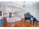 The home's foyer features a grand piano, detailed ceiling trim, and hardwood floors at 5200 Moore Rd, Suwanee, GA 30024