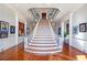 Stately foyer featuring a grand staircase and classic architectural details at 5200 Moore Rd, Suwanee, GA 30024