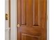 Stunning wooden front door with gold hardware and decorative panels adds classic charm to this home's entryway at 5200 Moore Rd, Suwanee, GA 30024