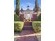 Front exterior showing a staircase entrance to the luxury home that's surrounded by mature landscaping at 5200 Moore Rd, Suwanee, GA 30024