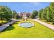 Stunning estate with circular drive, manicured lawn, and elegant fountain at 5200 Moore Rd, Suwanee, GA 30024
