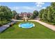 Majestic estate with circular drive and elegant water feature surrounded by lush landscaping at 5200 Moore Rd, Suwanee, GA 30024