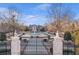 Elegant gated estate featuring a circular drive and impressive fountain at 5200 Moore Rd, Suwanee, GA 30024
