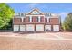 Spacious six-car garage with brick driveway, offering ample parking and storage at 5200 Moore Rd, Suwanee, GA 30024