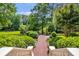 Beautiful manicured gardens with brick pathways and lush greenery create a serene outdoor space at 5200 Moore Rd, Suwanee, GA 30024