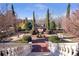 Stairway leading to landscaped gardens with topiaries, brick walkways, and mature trees at 5200 Moore Rd, Suwanee, GA 30024