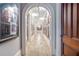 Arched hallway featuring recessed lighting and elegant decor along the walls at 5200 Moore Rd, Suwanee, GA 30024