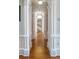 Hallway showcasing classic columns and hardwood floors at 5200 Moore Rd, Suwanee, GA 30024