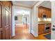 Hallway with hardwood floors leading to the kitchen, highlighting architectural details and layout at 5200 Moore Rd, Suwanee, GA 30024