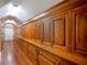 Long hallway featuring floor-to-ceiling wood cabinets and drawers for ample storage at 5200 Moore Rd, Suwanee, GA 30024