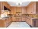 Traditional eat-in kitchen with light wood cabinets, stone countertops, and modern appliances at 5200 Moore Rd, Suwanee, GA 30024