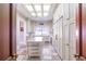 Gourmet kitchen with custom cabinetry, stone countertops, central island and skylight provides a bright, airy space at 5200 Moore Rd, Suwanee, GA 30024