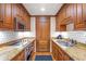 Classic kitchen with granite countertops and wood cabinetry at 5200 Moore Rd, Suwanee, GA 30024