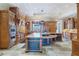 Spacious kitchen features wood cabinets, stone floors, granite countertops and stainless steel appliances at 5200 Moore Rd, Suwanee, GA 30024