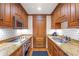 Traditional-style kitchen featuring custom wood cabinetry, granite countertops, and stainless steel appliances at 5200 Moore Rd, Suwanee, GA 30024