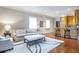 Open-concept living room flowing into the kitchen with hardwood floors and soft natural light at 5200 Moore Rd, Suwanee, GA 30024