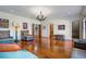 Spacious living room with hardwood floors, elegant chandelier, and comfortable seating, perfect for Gathering and guests at 5200 Moore Rd, Suwanee, GA 30024