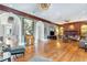 A large living room offers hardwood floors, high ceilings, and is accented by a fireplace and refined woodwork at 5200 Moore Rd, Suwanee, GA 30024