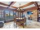 Inviting living room featuring a stone fireplace, wood beams, and a cozy seating area at 5200 Moore Rd, Suwanee, GA 30024