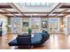 Bright living room with wood floors, white-framed French doors, coffered ceilings and a skylight at 5200 Moore Rd, Suwanee, GA 30024