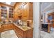 The pantry is equipped with wood cabinets, granite countertops, tile backsplash and plenty of storage at 5200 Moore Rd, Suwanee, GA 30024