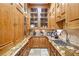 A pantry is conveniently equipped with wooden cabinets, granite countertops, and ample storage space at 5200 Moore Rd, Suwanee, GA 30024