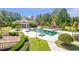 Inviting pool area with outdoor fireplace, lounge seating, and meticulous landscaping at 5200 Moore Rd, Suwanee, GA 30024