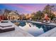 Beautiful pool featuring comfortable lounge furniture, bar and outdoor fireplace at 5200 Moore Rd, Suwanee, GA 30024
