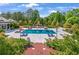 Aerial view of a private backyard pool, fireplace, and lush landscaping at 5200 Moore Rd, Suwanee, GA 30024