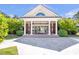 Elegant portico with white columns and manicured landscaping provides a grand entrance to the building at 5200 Moore Rd, Suwanee, GA 30024