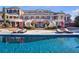 Exterior view of a luxury home from the expansive in-ground pool on a sunny day at 5200 Moore Rd, Suwanee, GA 30024