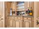 The wet bar area is equipped with custom cabinets, stone countertop, and wine storage at 5200 Moore Rd, Suwanee, GA 30024