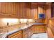 Butlers pantry/wet bar featuring custom cabinets and stone countertops at 5200 Moore Rd, Suwanee, GA 30024