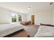Large bedroom contains three beds, light-colored carpet and two windows at 7247 Emma Ct, Douglasville, GA 30134