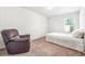 Bedroom featuring neutral colors with a bed and comfortable reading chair at 7247 Emma Ct, Douglasville, GA 30134