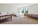 Bedroom features three beds, a light colored carpet, and a window at 7247 Emma Ct, Douglasville, GA 30134