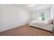 This bedroom features carpet flooring, a single window, and white colored walls at 7247 Emma Ct, Douglasville, GA 30134