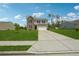Charming two-story home with brick accents, green lawn, long driveway, and a blue sky at 7247 Emma Ct, Douglasville, GA 30134