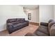 Cozy living room with plush brown sofas and neutral colored carpet at 7247 Emma Ct, Douglasville, GA 30134
