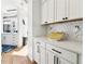 Modern white kitchen with hexagonal tile backsplash and stainless steel appliances at 260 18Th Nw St # 10226, Atlanta, GA 30363