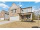 Two-story brick home with a front porch and attached garage at 5010 Ethans Cove Dr, Austell, GA 30106