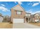 Two-story brick home with a front porch and attached garage at 5010 Ethans Cove Dr, Austell, GA 30106