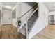 Light-filled entryway with staircase, hardwood floors, and access to kitchen at 5010 Ethans Cove Dr, Austell, GA 30106