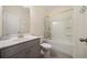 Updated bathroom with tub/shower combo and gray vanity at 3075 Westpoint Cir, Snellville, GA 30078