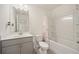 Clean bathroom with a tub shower, toilet, and gray vanity at 3075 Westpoint Cir, Snellville, GA 30078