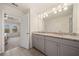 Bathroom with granite countertop, double vanity and access to bedroom at 3075 Westpoint Cir, Snellville, GA 30078